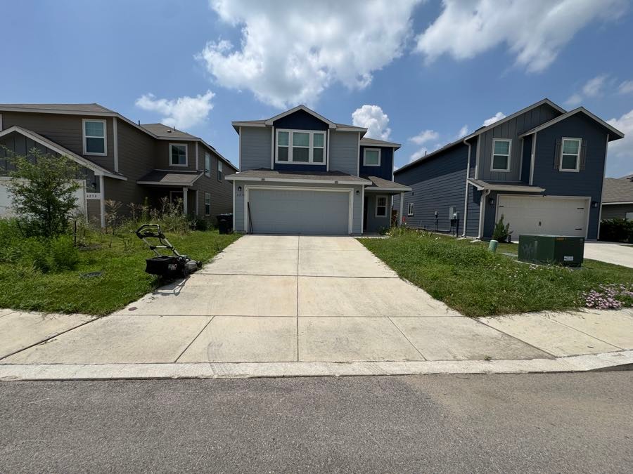 Overgrown front yard in NE San Antonio before Simply Lawn cleanup